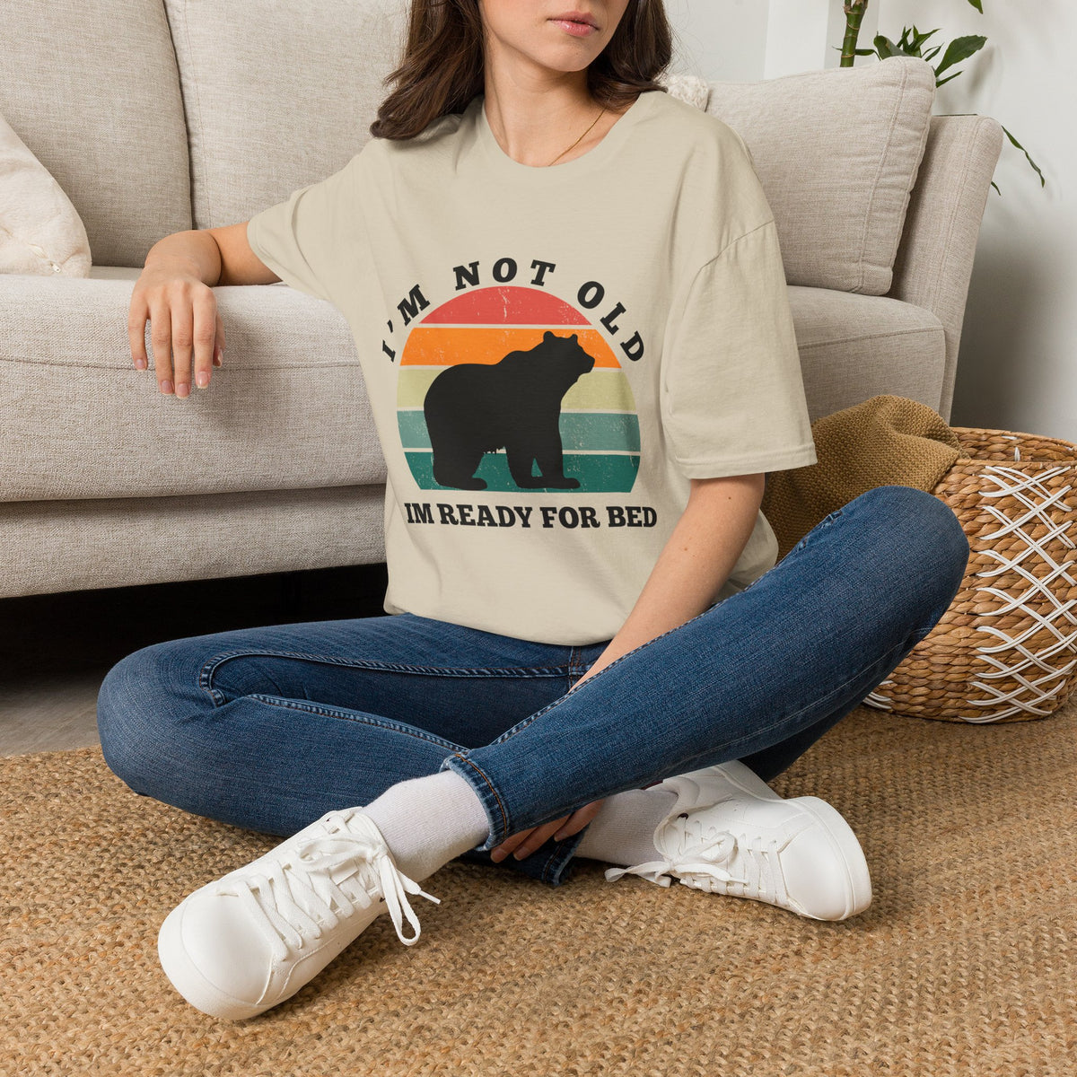 A sand short-sleeve graphic T-shirt  The shirt has a retro sunset-style circular graphic with a bear silhouette and the text 'I'M NOT OLD IM READY FOR BED.