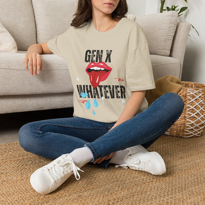 A woman sat on a rug next to a couch wearing a sand short-sleeve graphic t-shirt featuring the text 'GEN X WHATEVER' in black, with a graphic of red lips. 