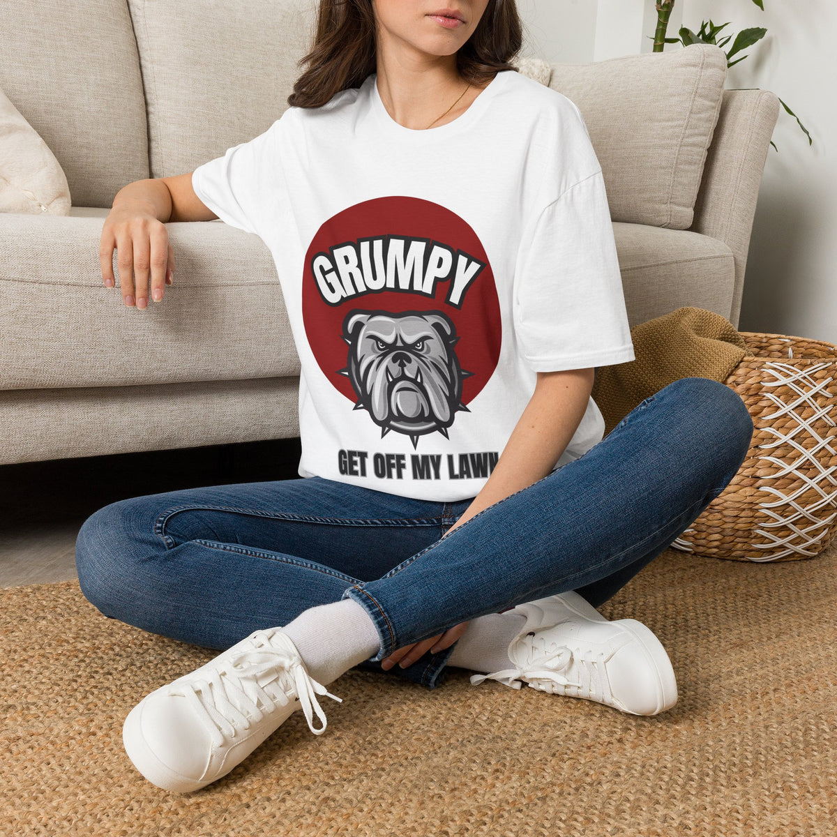 A white short-sleeve graphic T-shirt  The shirt has a red circular graphic with the word "GRUMPY" above a bulldog illustration and the phrase "GET OFF MY LAWN.