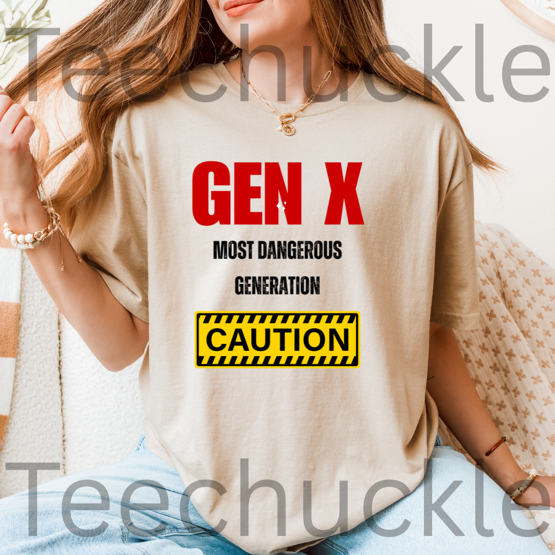 A woman wearing a sand graphic t-shirt with the text 'GEN X MOST DANGEROUS GENERATION' and a yellow caution box. 