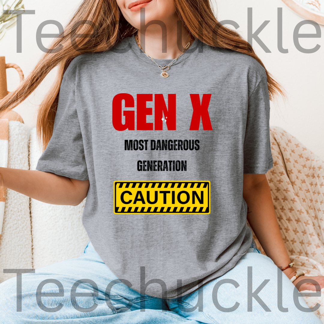 A woman wearing a gray graphic T-shirt with bold red and black text reading 'GEN X MOST DANGEROUS GENERATION' and a yellow caution-style 'CAUTION' box graphic. The photo is cropped from the mouth down, with a soft indoor background