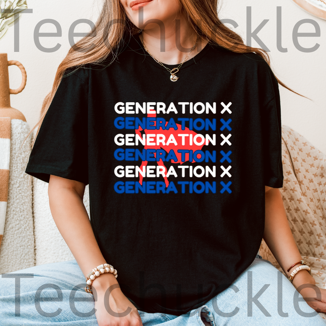 A woman wearing a black graphic t-shirt with the text 'GENERATION X' repeated in white and blue, overlaid with a red paint splatter design. The photo is taken in a cozy indoor setting with a neutral background.