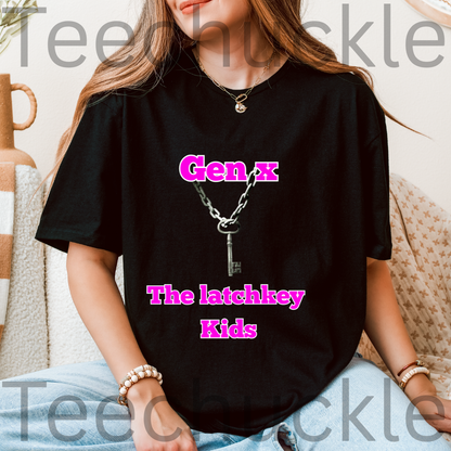 A woman wearing a black graphic t-shirt with pink text reading 'Gen X The latchkey Kids' and a silver key necklace printed on the front, sitting in a cozy indoor setting.
