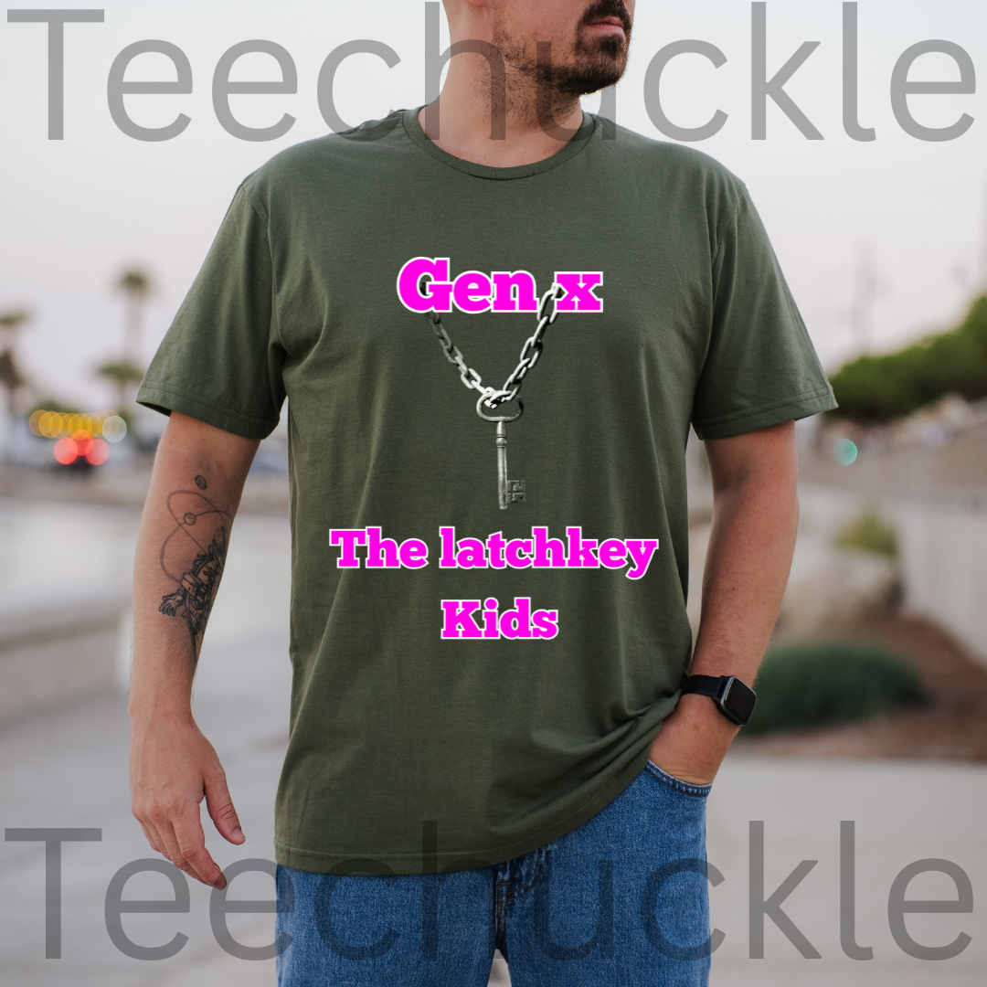 A man wearing a green graphic t-shirt with a silver key and chain design and pink text reading 'Gen x The latchkey Kids', with a blurry outdoor setting in the background.