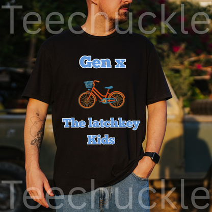 A man wearing a black graphic t-shirt with the text 'Gen x The latchkey Kids' in blue and an illustration of an orange bicycle. The photo is taken outdoors in warm, natural light with a blurred background of trees and a vehicle.