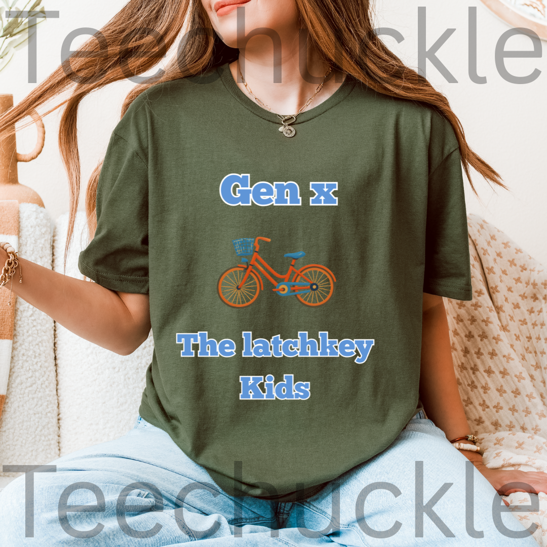 A woman wearing a green graphic t-shirt with the text 'Gen x The latchkey Kids' in blue and an illustration of an orange bicycle. The photo is taken in a cozy indoor setting with a textured blanket.