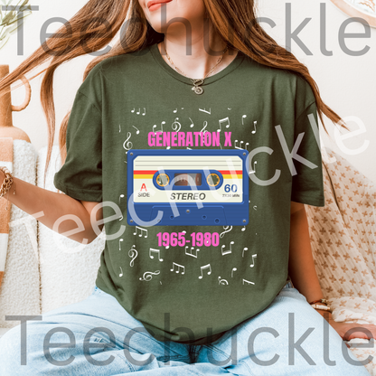 A woman wearing a green graphic t-shirt featuring a retro blue cassette tape design with pink text reading 'GENERATION X 1965-1980' and white music notes, paired with light blue jeans.
