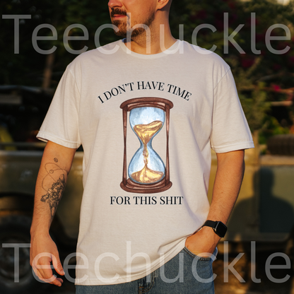 A man wearing a white graphic t-shirt with a humorous quote and an hourglass illustration. The text reads 'I DON'T HAVE TIME' above the graphic and 'FOR THIS SHIT' below it.