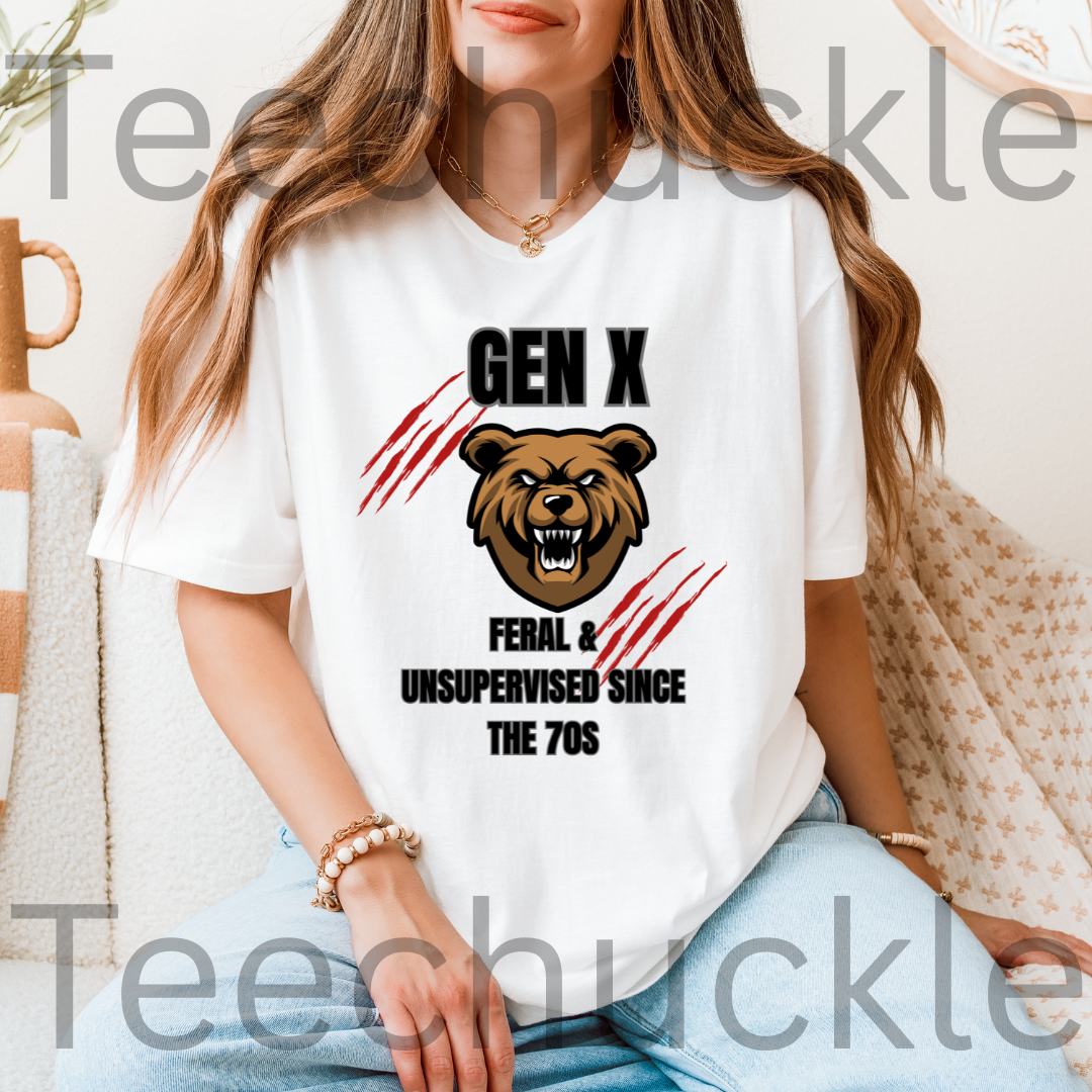 A woman wearing a white graphic t-shirt with a brown bear illustration and the text 'GEN X FERAL & UNSUPERVISED SINCE THE 70S'.