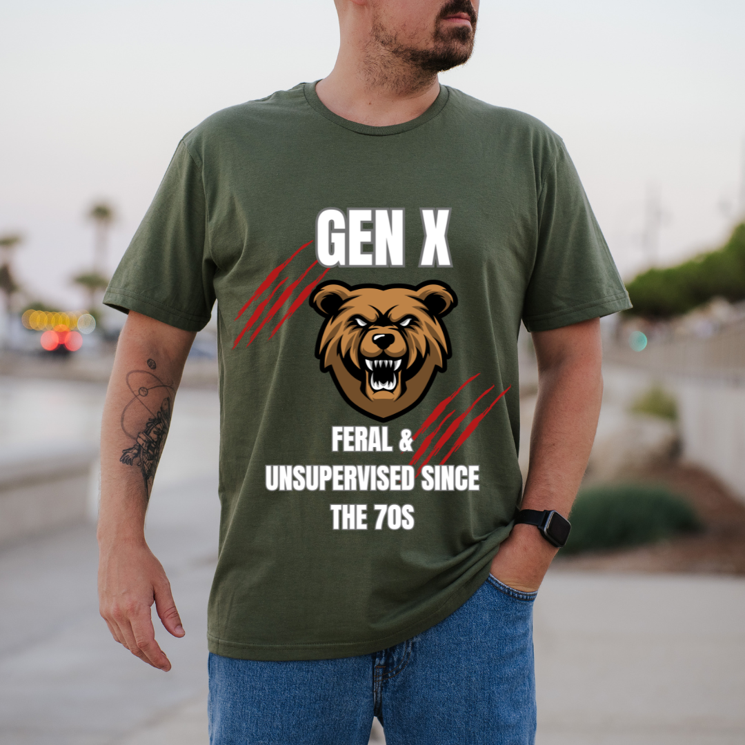 A man wearing a green graphic t-shirt with a 'Gen X Feral & unsupervised since the 70s' bear design, standing outdoors in a blurred city setting.