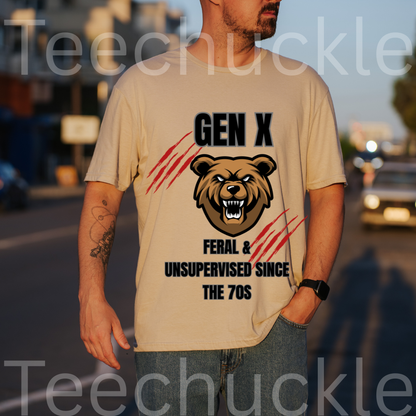A man wearing a sand graphic t-shirt with a bear head design and the text 'GEN X FERAL & UNSUPERVISED SINCE THE 70S' on the front, standing outdoors on a street at sunset.