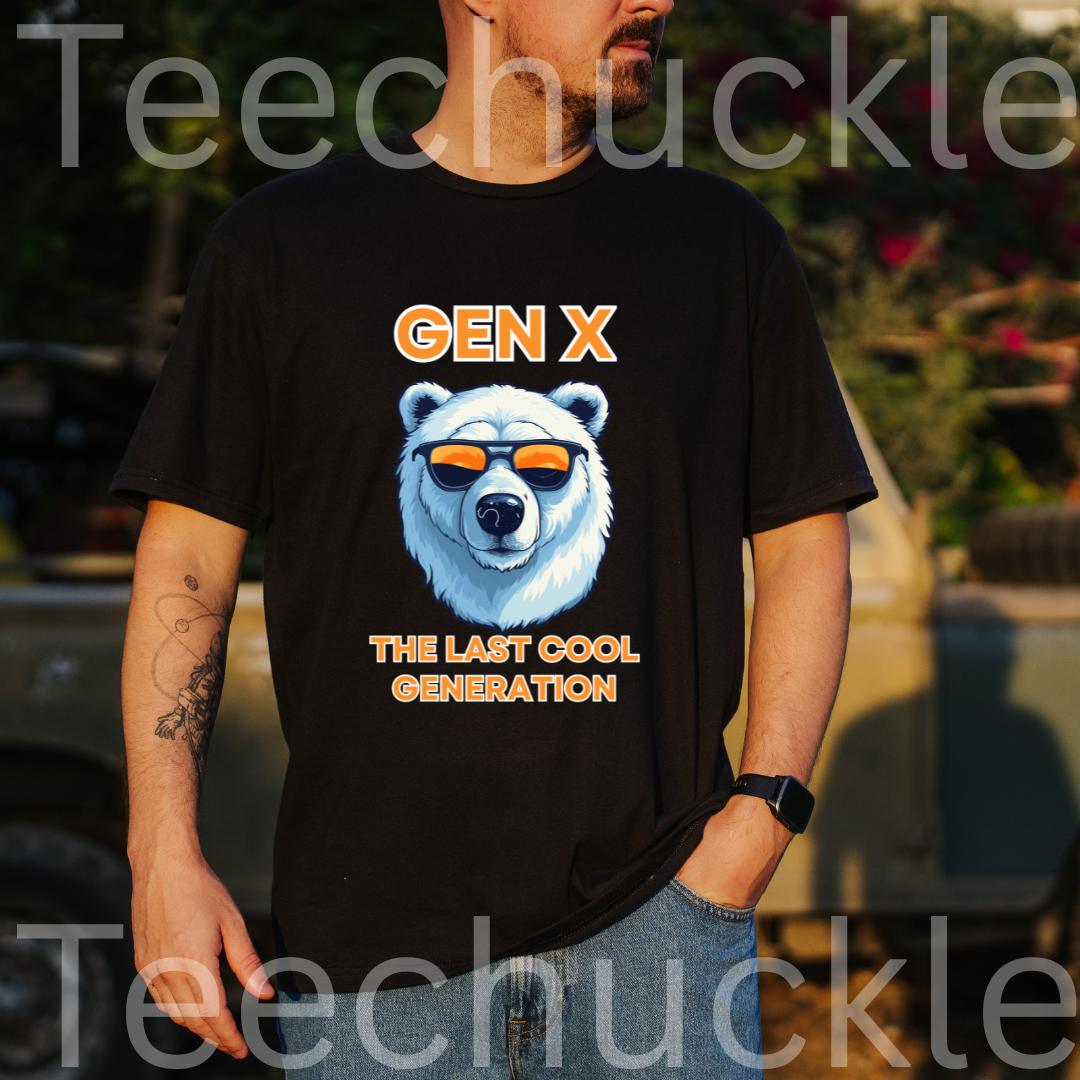A man stood outside wearing a black short-sleeve graphic T-shirt laid flat on a wood plank background, with black text reading 'Gen x' and 'The last cool generation' a  polar bear illustration. 