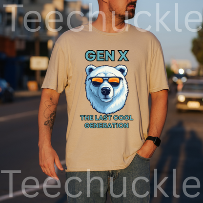 A man wearing a sand graphic t-shirt with a polar bear wearing sunglasses and the text 'GEN X THE LAST COOL GENERATION'. The background is a blurred street scene at sunset