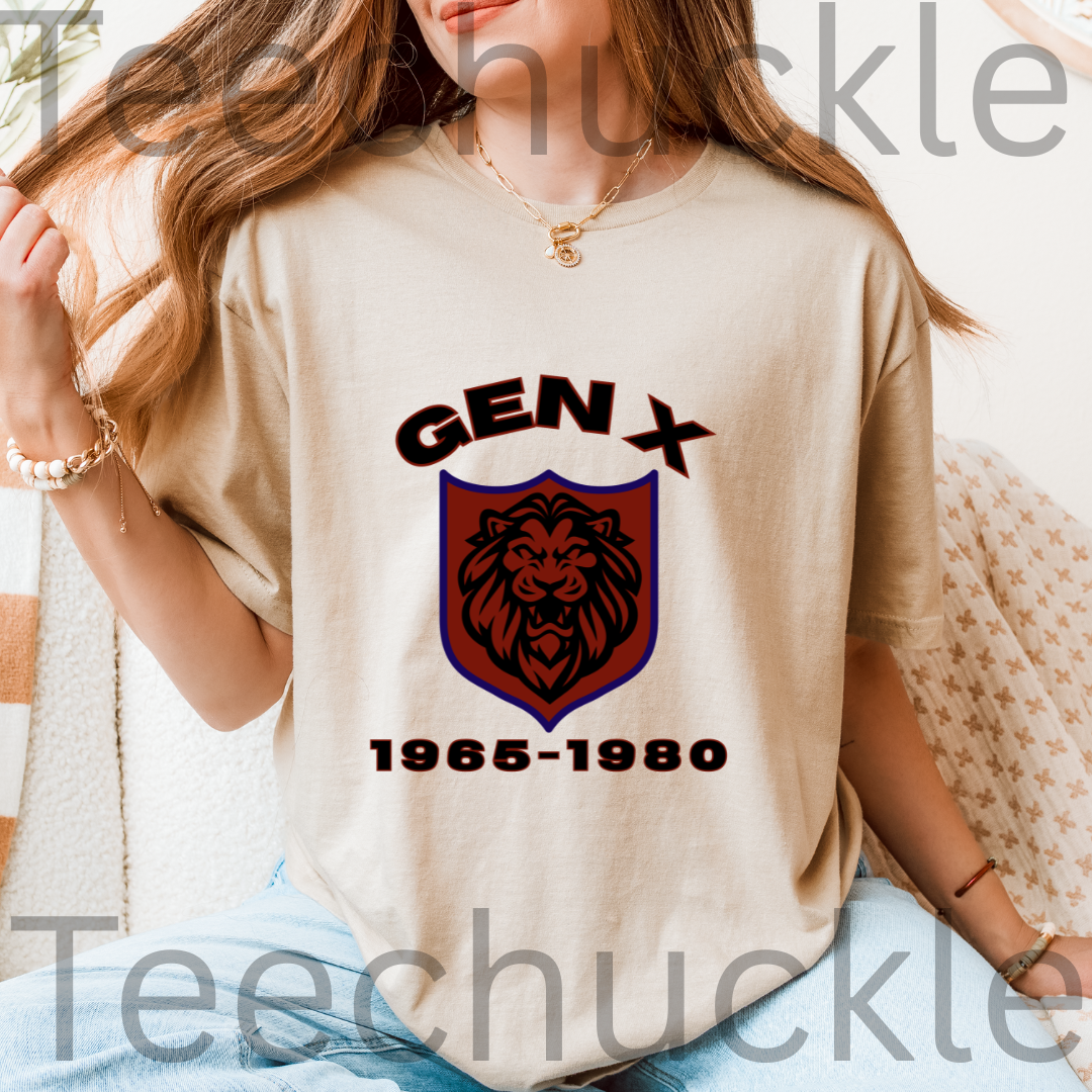 A woman wearing a sand graphic t-shirt with a 'GEN X 1965-1980' lion crest design.