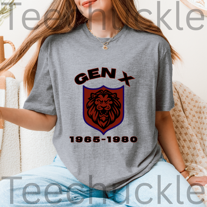A woman wearing a gray graphic t-shirt with a 'GEN X 1965-1980' lion crest design, sitting on a beige textured couch. 