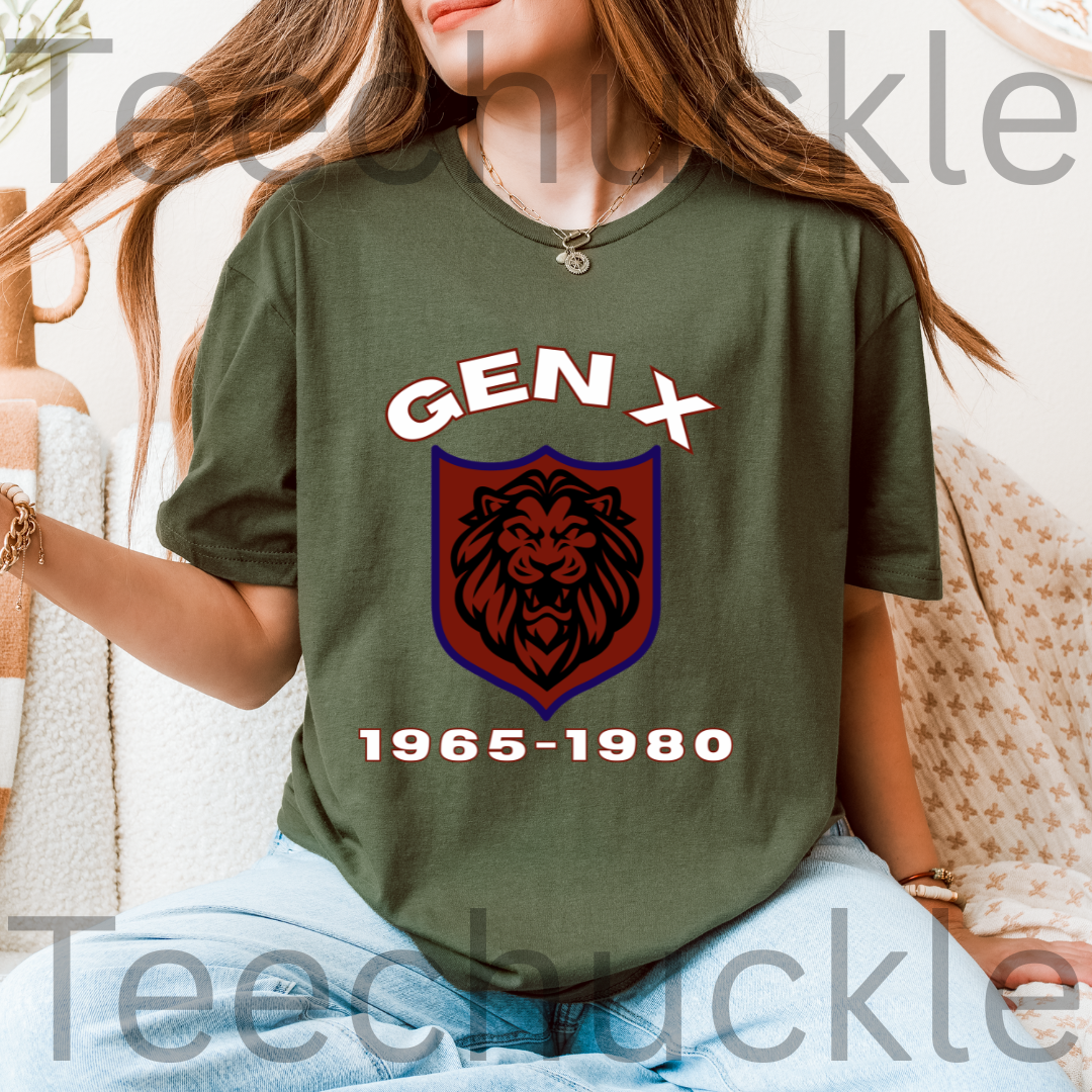 A woman wearing a green graphic t-shirt with a 'GEN X 1965-1980' lion crest design, paired with light blue jeans in a cozy indoor setting.