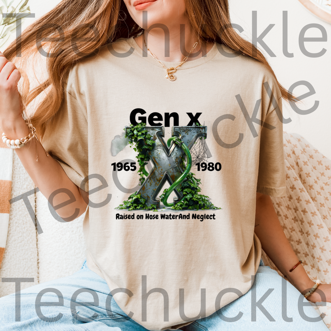 A woman sat wearing a sand graphic t-shirt featuring the text 'Gen x 1965-1980 raised on hose water and neglect' in black, with an illustration of a metalic X with foliage and garden hose in the center. 