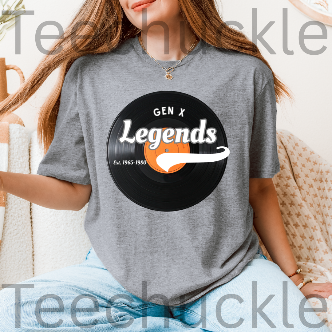 A woman wearing a gray graphic t-shirt with a black vinyl record design that reads 'GEN X Legends Est. 1985-2024' 