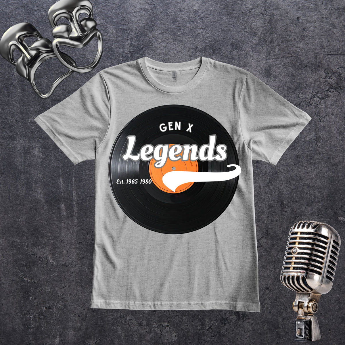 A gray crewneck t-shirt featuring a retro graphic of a black vinyl record with the text 'GEN X Legends Est. 1965-1980' styled on a dark textured background with vintage silver microphones.