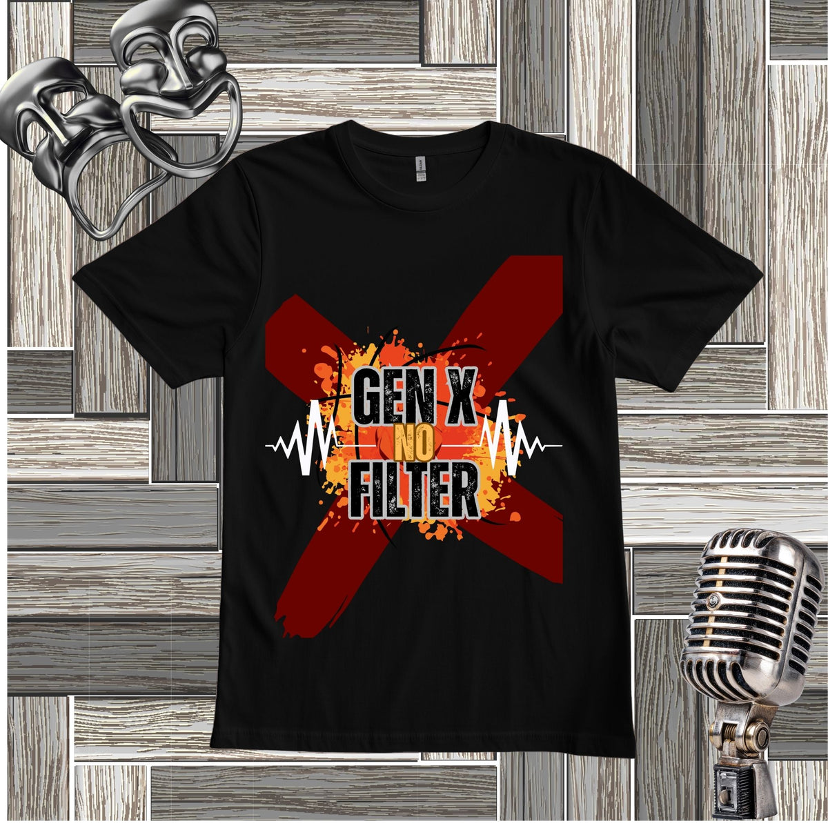 A black short-sleeve graphic t-shirt displayed flat against a gray wood-paneled background with decorative props, including a silver theater mask, a vintage microphone. The shirt features a large red 'X' graphic with a yellow-orange flame center, and the text 'GEN X NO FILTER'.