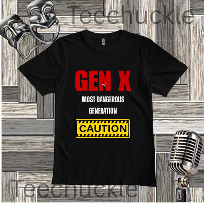 A black short-sleeve graphic T-shirt laid flat on a wood plank background, with large red and white text reading 'GEN X MOST DANGEROUS GENERATION' and a yellow caution-style box below. Decorative vintage-style props including a silver mask, microphone, and metallic object appear around the shirt