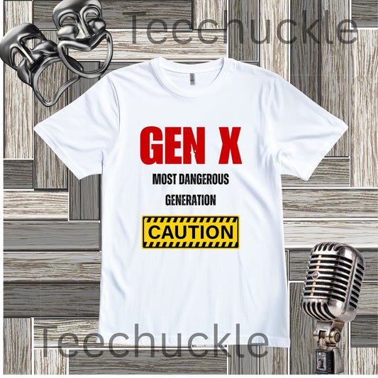 A white short-sleeve graphic T-shirt laid flat on a wood plank background, with red and black text reading 'GEN X MOST DANGEROUS GENERATION' and a yellow caution-style box. Decorative vintage microphones and comedy masks are placed around the shirt