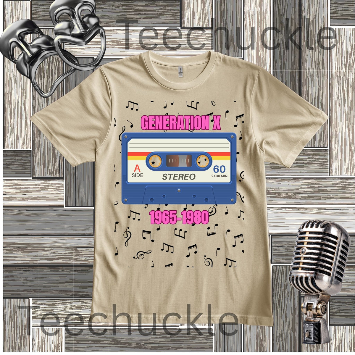 A sand graphic t-shirt featuring a retro cassette tape design with the text 'GENERATION-X 1965-1980' in pink. The t-shirt is displayed on a gray wood-plank background with vintage microphone and headphones props.