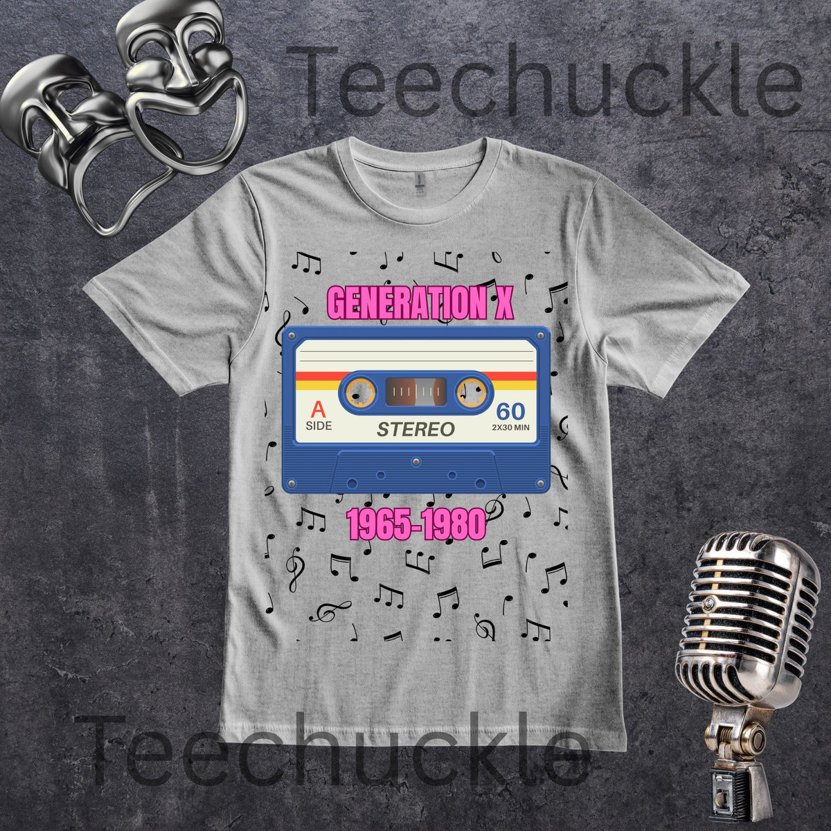 A light gray graphic T-shirt laid flat on a dark textured background, featuring a retro cassette tape design with pink text 'GENERATION X' and '1965-1980' plus scattered music notes, with decorative comedy masks and a vintage microphone around the shirt.