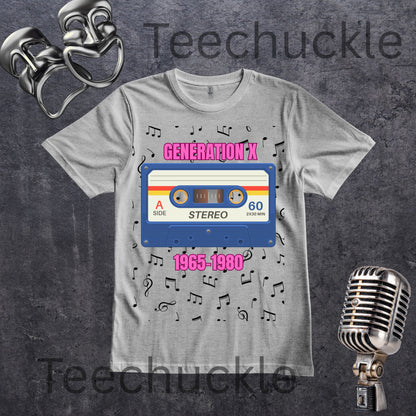 A light gray graphic T-shirt laid flat on a dark textured background, featuring a retro cassette tape design with pink text 'GENERATION X' and '1965-1980' plus scattered music notes, with decorative comedy masks and a vintage microphone around the shirt.
