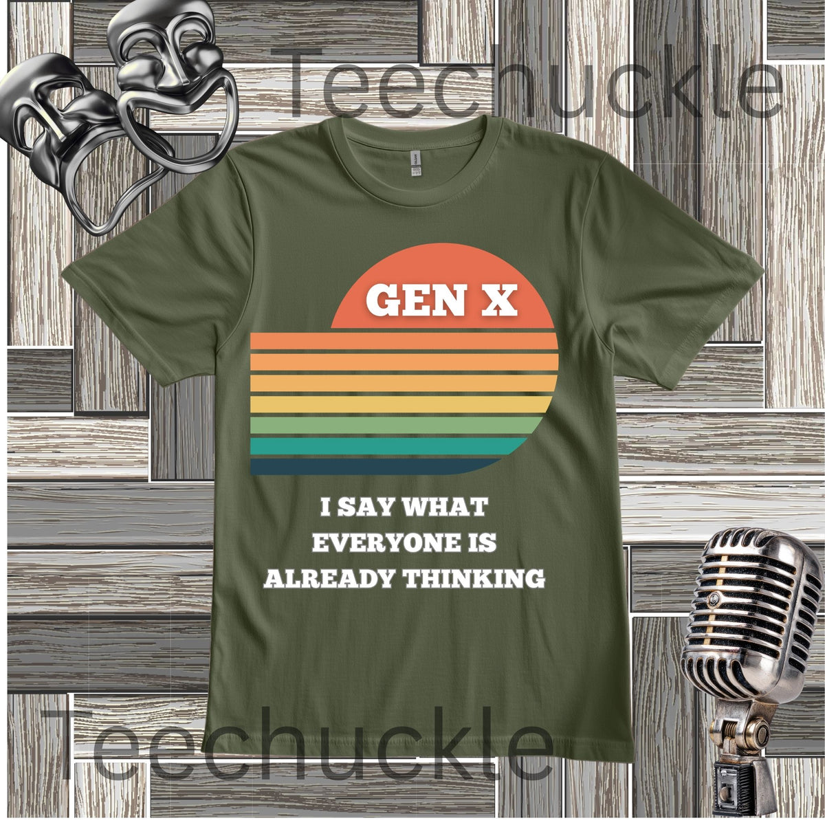 A green graphic t-shirt featuring a retro sunset design with the text 'GEN X I SAY WHAT EVERYONE IS ALREADY THINKING'. The t-shirt is displayed on a gray wood-paneled background with vintage props, including a silver theater mask on the top left, a silver microphone on the bottom right