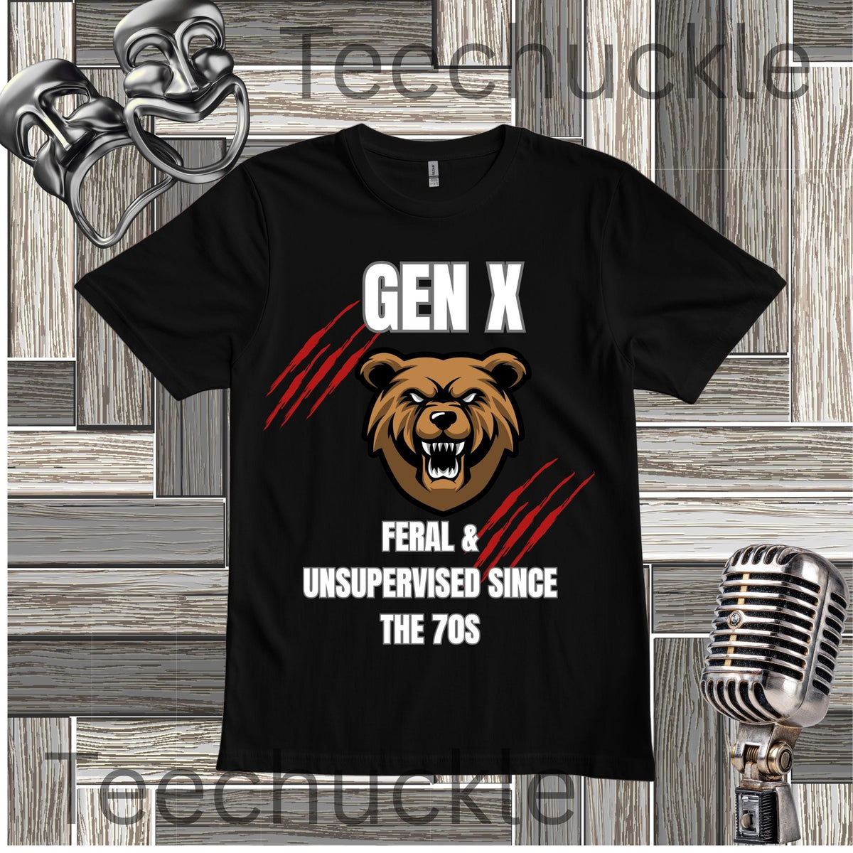A black short-sleeve graphic T-shirt displayed flat against a rustic wood plank background with vintage-style microphone and mask props. The shirt features a roaring brown bear face with white text reading 'GEN X' above and 'FERAL & UNSUPERVISED SINCE THE 70S' below, accented by red claw marks.