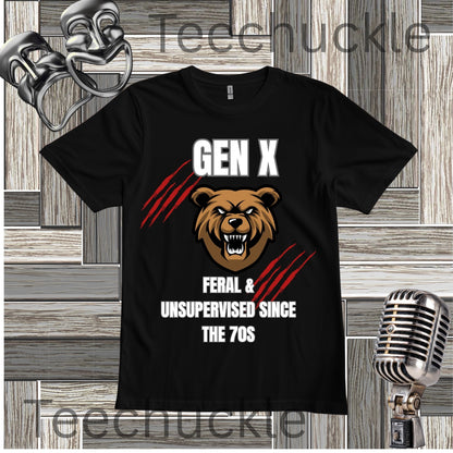 A black short-sleeve graphic T-shirt displayed flat against a rustic wood plank background with vintage-style microphone and mask props. The shirt features a roaring brown bear face with white text reading 'GEN X' above and 'FERAL & UNSUPERVISED SINCE THE 70S' below, accented by red claw marks.