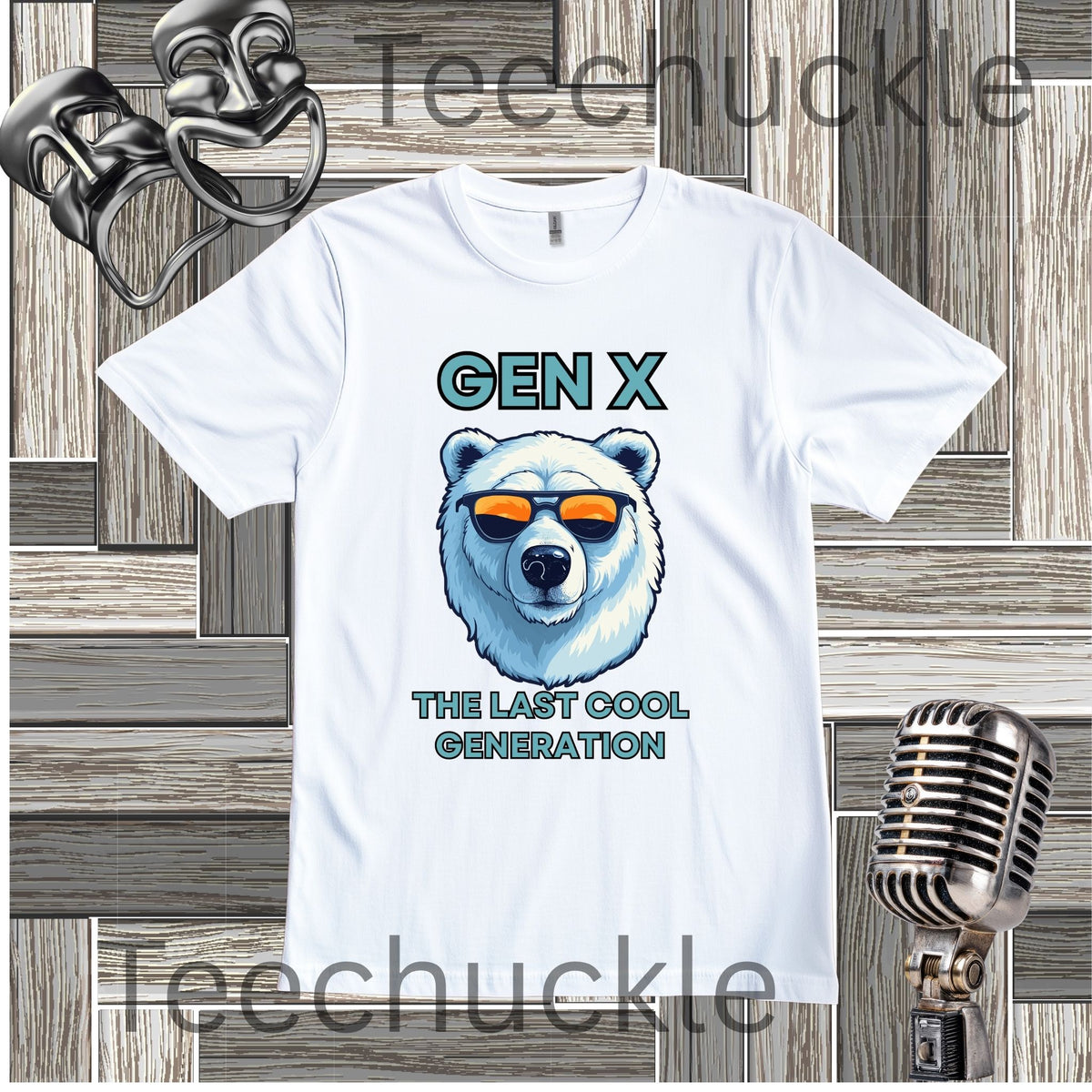 A white short-sleeve graphic T-shirt laid flat on a wood plank background, with black text reading 'Gen x' and 'The last cool generation' a  polar bear illustration. Decorative vintage theater masks and a retro microphone appear around the shirt.