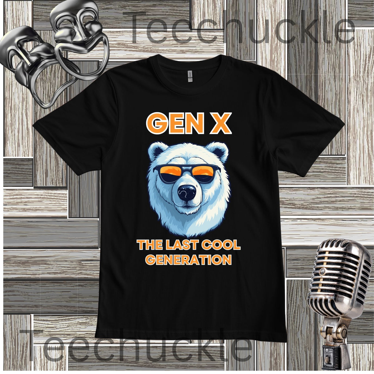 A white short-sleeve graphic T-shirt laid flat on a wood plank background, with black text reading 'Gen x' and 'The last cool generation' a  polar bear illustration. Decorative vintage theater masks and a retro microphone appear around the shirt.