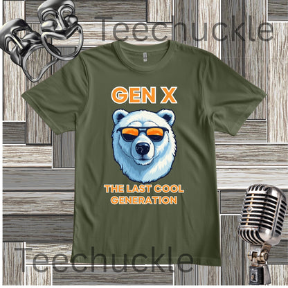 A green short-sleeve graphic T-shirt laid flat on a wood plank background, with orange text reading 'Gen x' and 'The last cool generation' a  polar bear illustration. Decorative vintage theater masks and a retro microphone appear around the shirt.