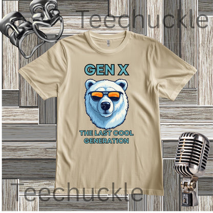 A sand short-sleeve graphic T-shirt laid flat on a wood plank background, with black text reading 'Gen x' and 'The last cool generation' a  polar bear illustration. Decorative vintage theater masks and a retro microphone appear around the shirt.
