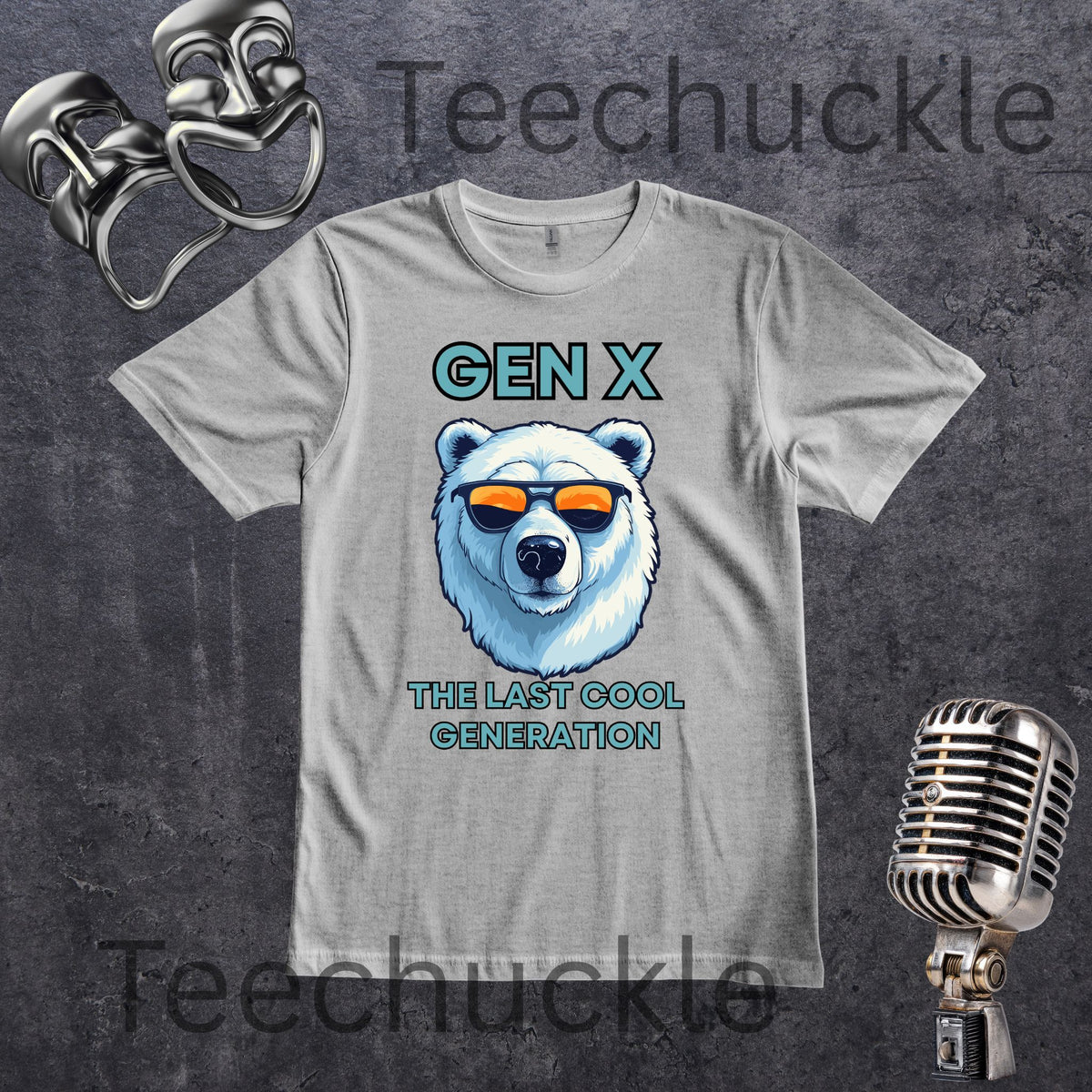 A gray graphic T-shirt laid flat on a dark textured background, featuring a polar bear illustration wearing orange-tinted sunglasses with the text 'GEN X THE LAST COOL GENERATION' in teal. Decorative metallic propsaround the shirt.