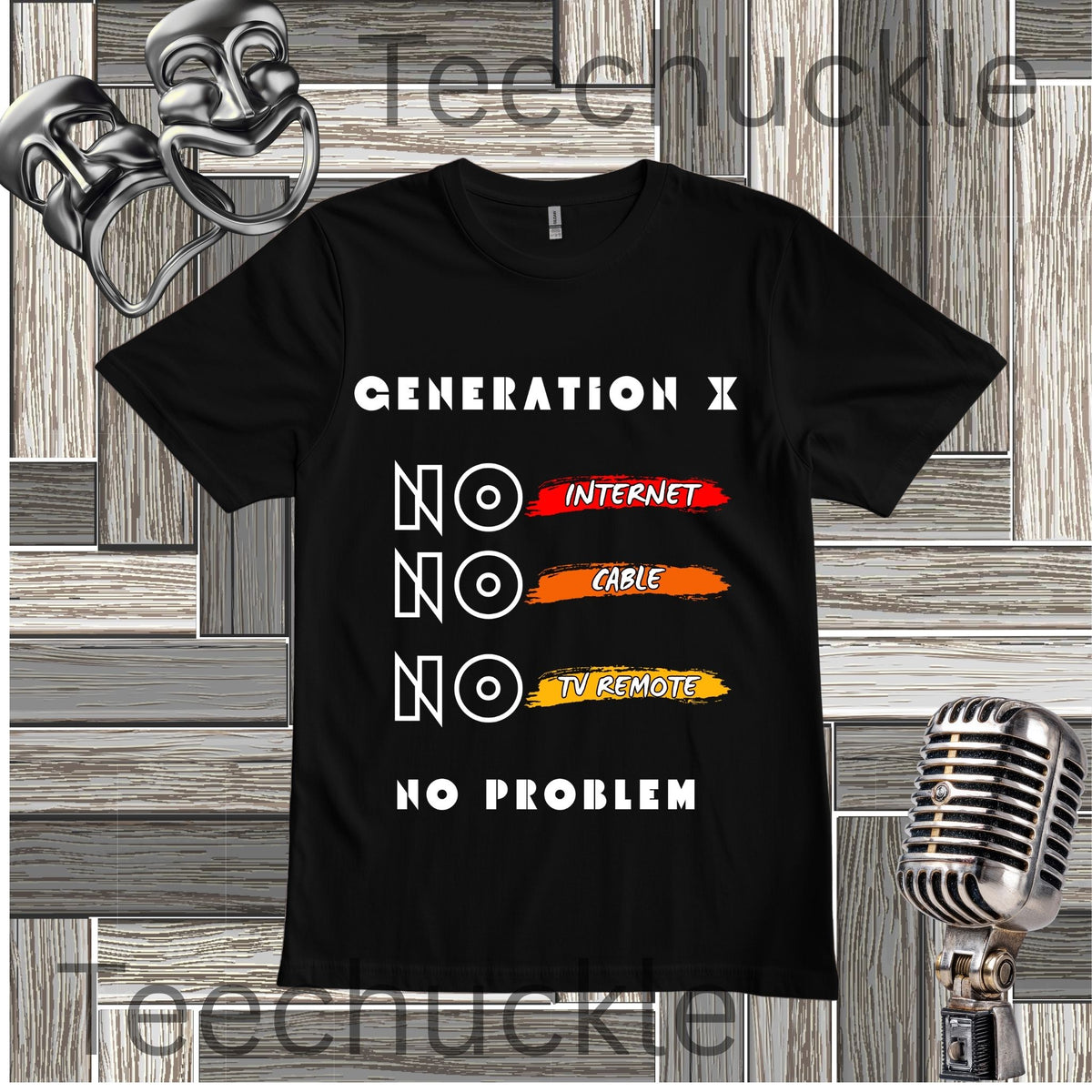 A black t-shirt with "GENERATION X, NO INTERNET, NO CABLE, NO TV REMOTE, NO PROBLEM" acented with red, orange and yellow brush strokes, on a wooden background with vintage microphone and comedy masks