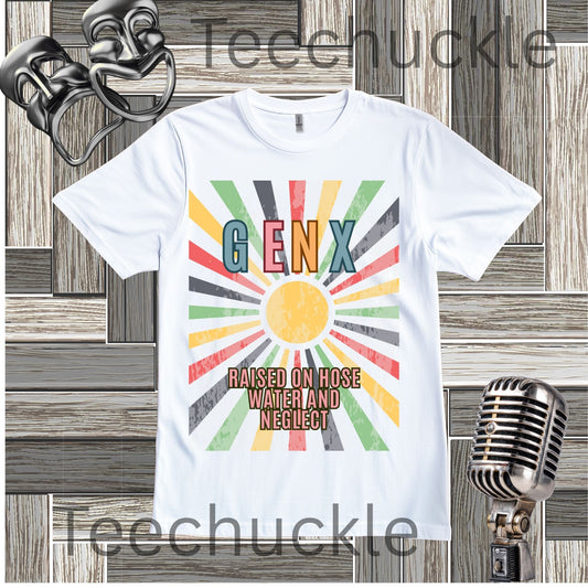 A white short-sleeve graphic T-shirt laid flat on a wood plank background, featuring a colorful retro sunburst design with the text 'GENX RAISED ON HOSE WATER AND NEGLECT.' Decorative vintage microphones and a microphone and comedy masks appear at the top left and bottom right.