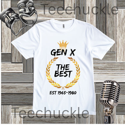 White Gen X The Best t-shirt with crown and gold wreath graphic flat lay on a wooden background
