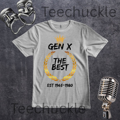 A flat lay grey t-shirt with gold crown and wreath graphic and black text saying Gen X The Best est 1865-1980 on a slate grey background