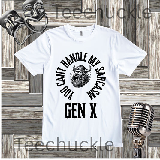 A white short-sleeve graphic t-shirt with a black circular print featuring a roaring viking man and the text 'YOU CAN'T HANDLE MY SARCASM GEN X'. The shirt is displayed on a rustic wood panel background with vintage-style props, including a silver microphone and a comedy mask