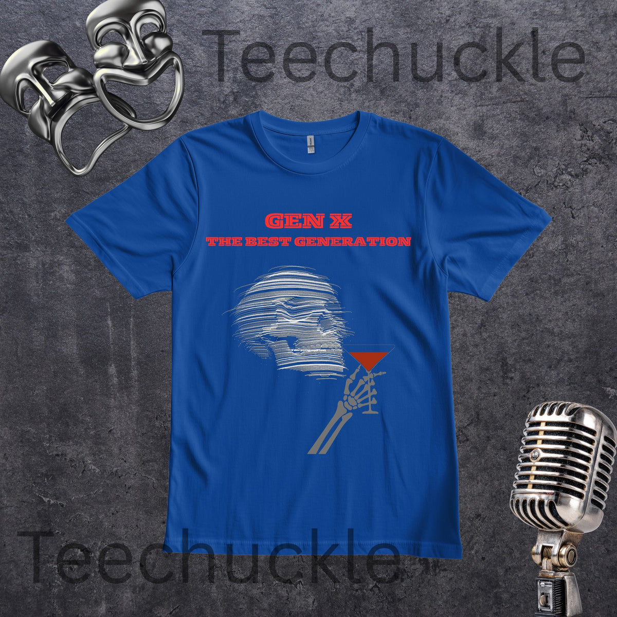 A blue short-sleeve graphic T-shirt laid flat on a dark textured background, with red text reading 'GEN X THE BEST GENERATION' and a gray-and-red cocktail-slice graphic. The shirt is styled with metal comedy masks and a vintage microphone.