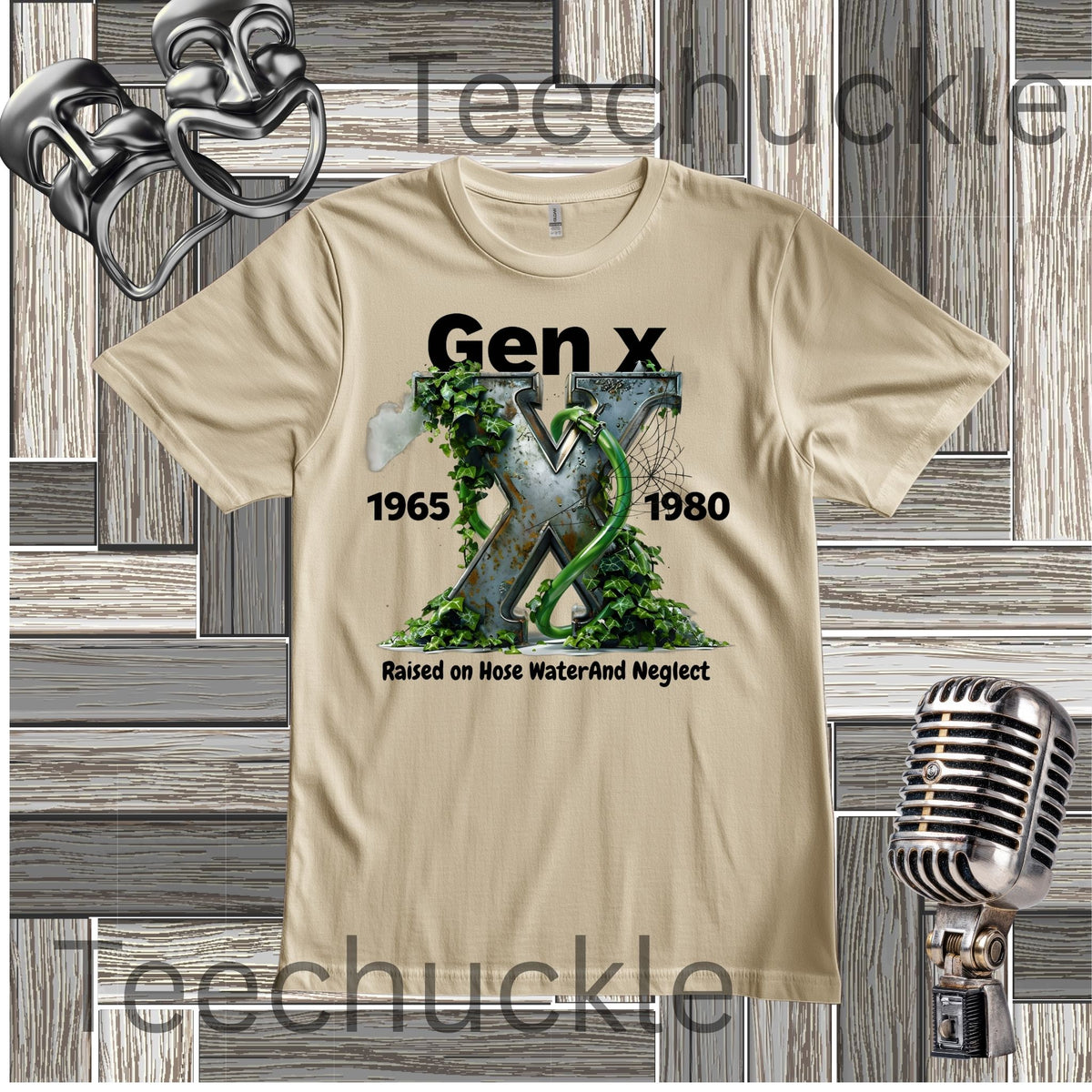 A sand graphic t-shirt featuring the text 'Gen x 1965-1980 raised on hose water and neglect' in black, with an illustration of a metalic X with foliage and garden hose in the center. The t-shirt is displayed on a gray wood panel background with vintage-style props, including a silver microphone and a metal object in the corners.