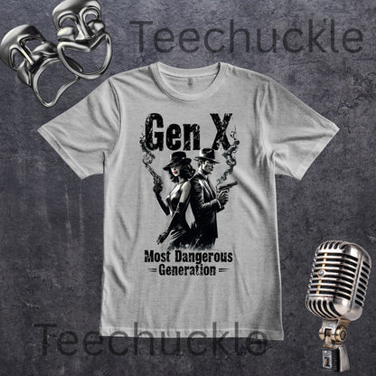 A light gray crewneck t-shirt featuring a black graphic of a man and a woman in vintage suits and top hats holding smoking guns, with the text 'Gen X' and 'Most Dangerous Generation'. The shirt is displayed on a textured dark gray background with vintage microphone and comedy masks props