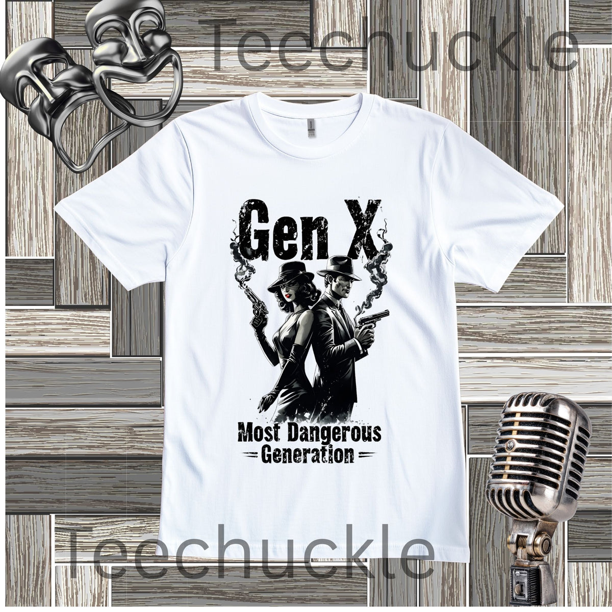 A white short-sleeve graphic t-shirt featuring a black print of a woman and a man holding guns with smoke, and the text 'Gen X Most Dangerous Generation'. The shirt is displayed on a gray wood panel background with a vintage microphone and comedy masks as props.