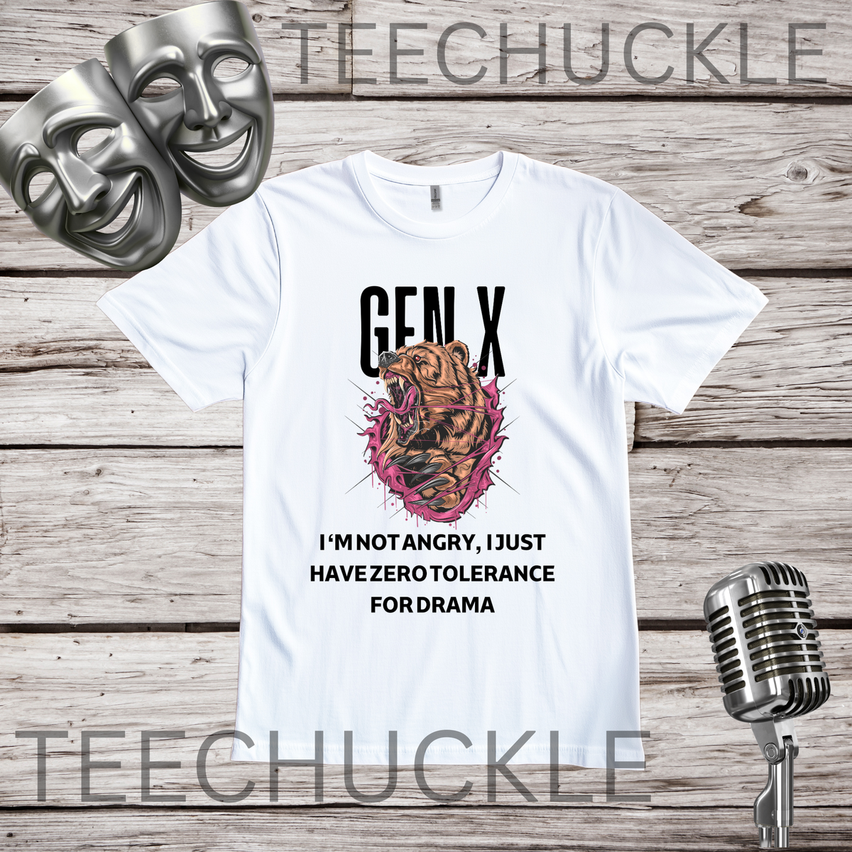 A white graphic t-shirt displayed on a rustic wood background, featuring a 'GEN X' bear illustration and the text 'I'M NOT ANGRY, I JUST HAVE ZERO TOLERANCE FOR DRAMA'. The shirt is styled with two silver theater masks, a vintage microphone.