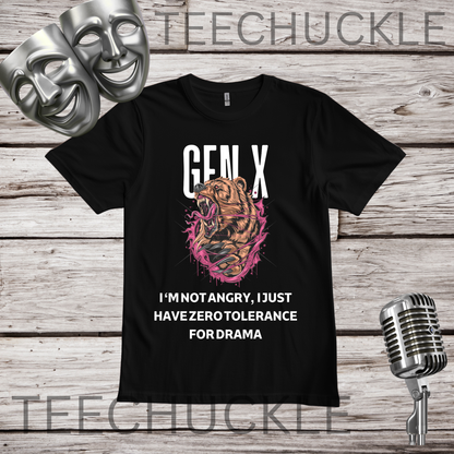 A black graphic t-shirt featuring a roaring bear illustration with pink paint splatters and the text 'GEN-X I'M NOT ANGRY, I JUST HAVE ZERO TOLERANCE FOR DRAMA'. The t-shirt is displayed on a rustic wood background with silver theater masks, a vintage microphone