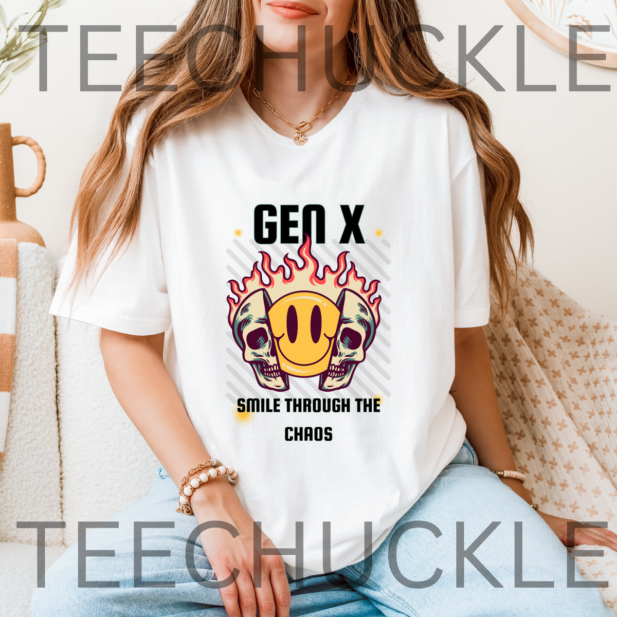 A woman wearing a white graphic t-shirt with a 'Gen X Smile Through The Chaos' design featuring skulls, a smiley face, and flames.
