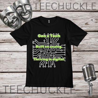 A black short-sleeve graphic t-shirt displayed flat on a rustic wood background, featuring a white circuit board with green text "GEN X TECH, BUILT ON ANALOG, THRIVING IN DIGITAL". The image includes decorative props like two silver theater masks, a vintage microphone.